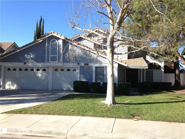 a front view of house with a garden