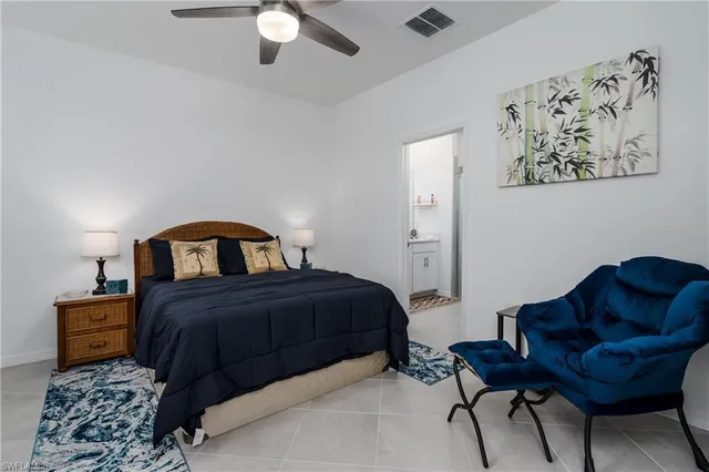 a bedroom with a bed couch and a window