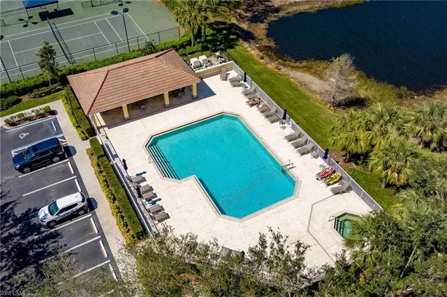 an aerial view of a house with a yard and swimming pool