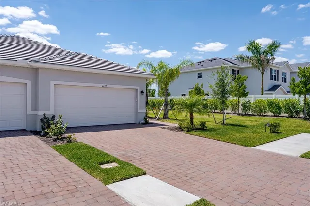 a front view of house with a garden