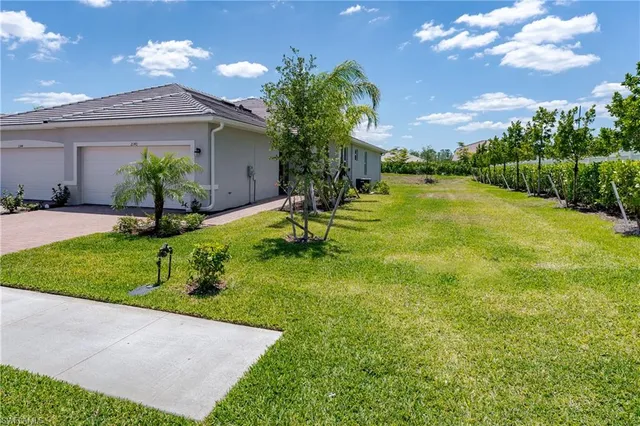 a view of a house with pool and a yard