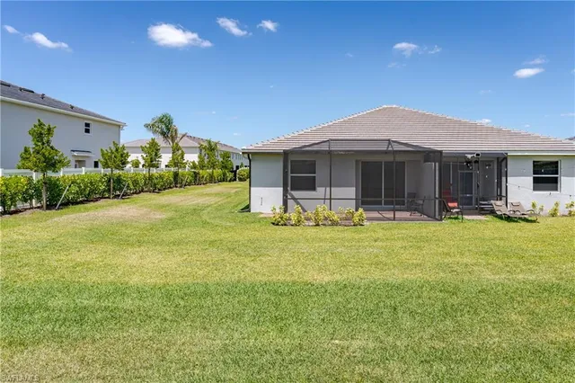 a view of a house with a backyard patio and swimming pool