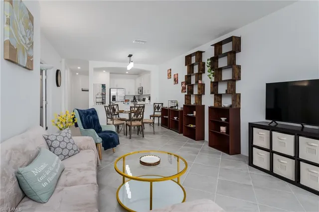 a living room with furniture a rug and a flat screen tv