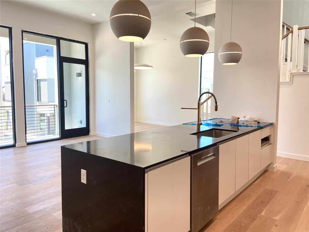 1111 Raiford Road, Unit 128 Carrollton, TX 75007 - Photo 5 of 18 Waterfall quartz countertop. Large kitchen, living, and dining room is perfect for entertaining.