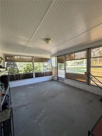 a view of room with furniture and floor to ceiling window