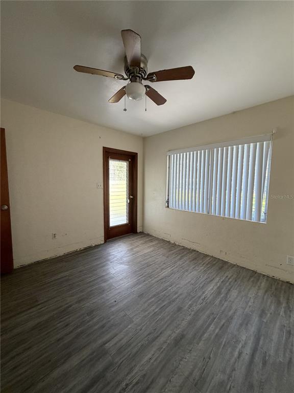 6131 Lafayette Street New Port Richey, FL 34652 - Photo 25 of 34 a view of an empty room with a window and wooden floor