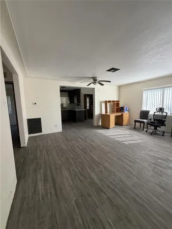 a view of a livingroom with furniture hardwood floor and a ceiling fan