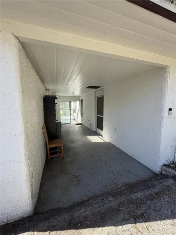 a view of entryway and hall with a chair