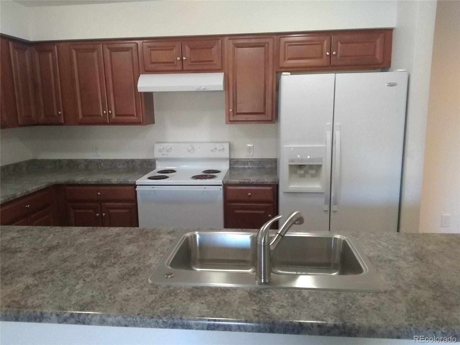 Undisclosed Address Aurora, CO 80011 - Photo 3 of 14 a kitchen with a refrigerator sink and stove