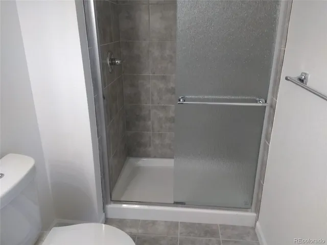 a bathroom with a shower and toilet