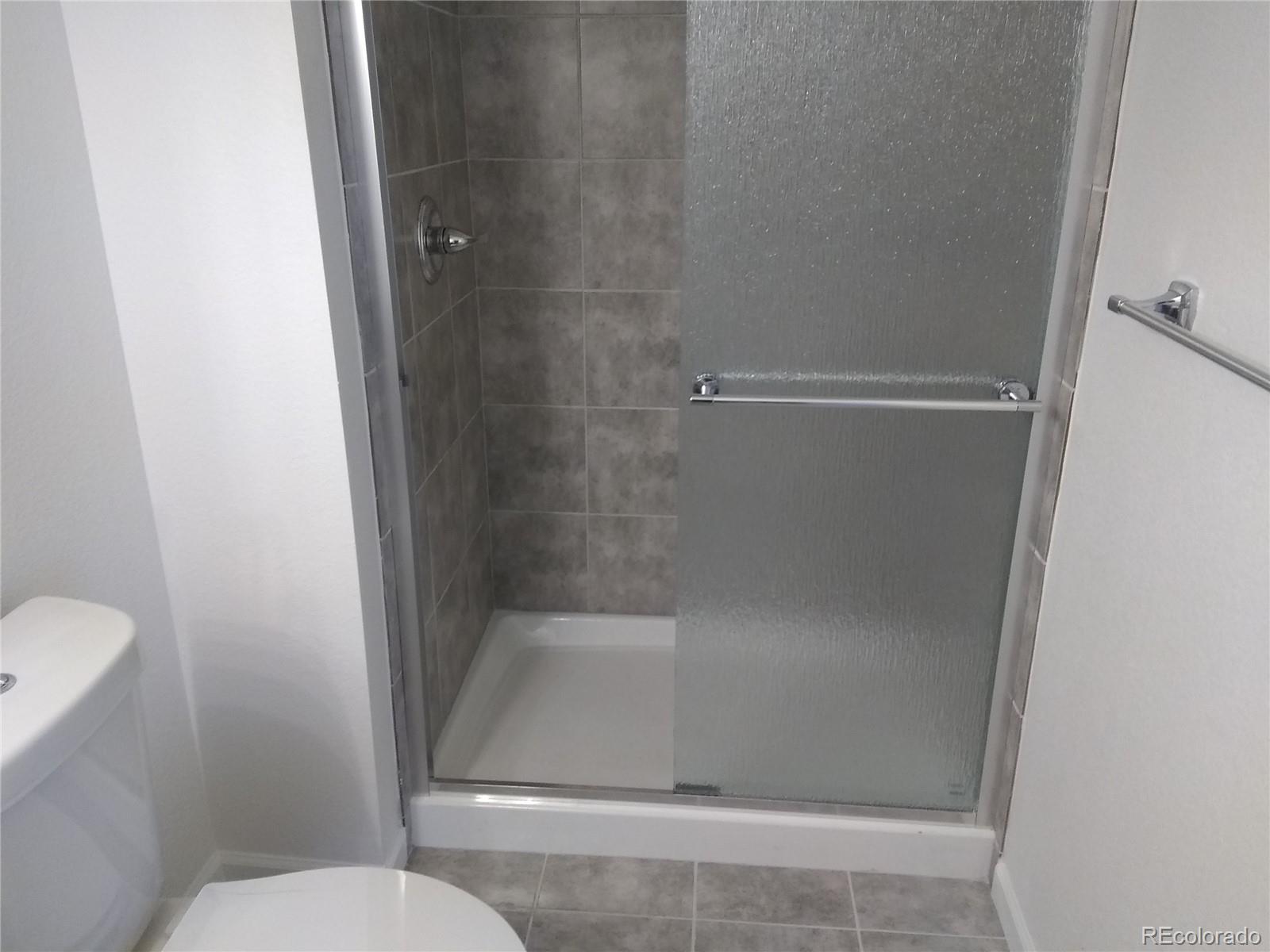 Undisclosed Address Aurora, CO 80011 - Photo 9 of 14 a bathroom with a shower and toilet