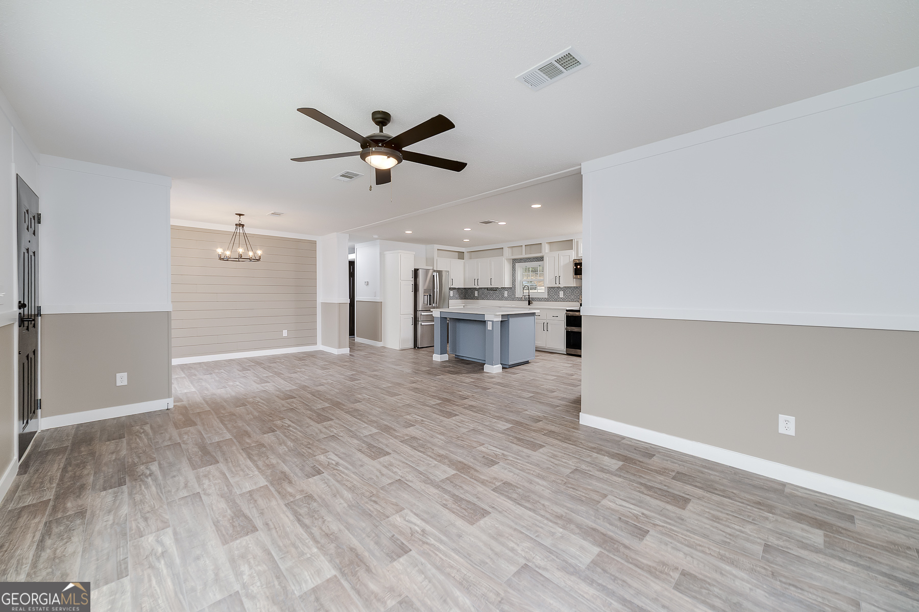 595 Barnetts Bridge Road Jackson, GA 30233 - Photo 15 of 47 a view of a room with wooden floor and a ceiling fan