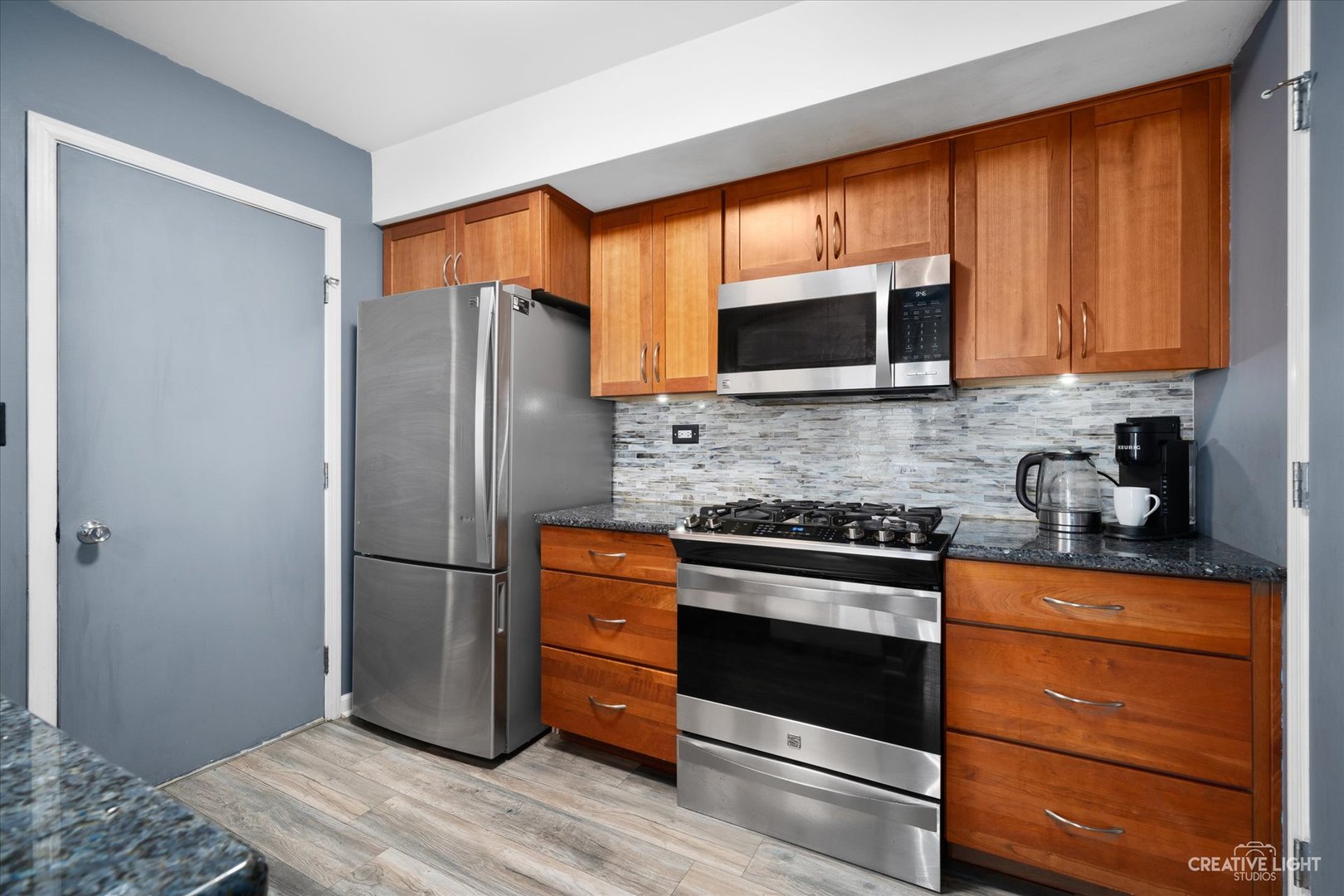 368 Bunker Hill Circle Aurora, IL 60504 - Photo 6 of 15 a kitchen with granite countertop wooden cabinets stainless steel appliances and a window