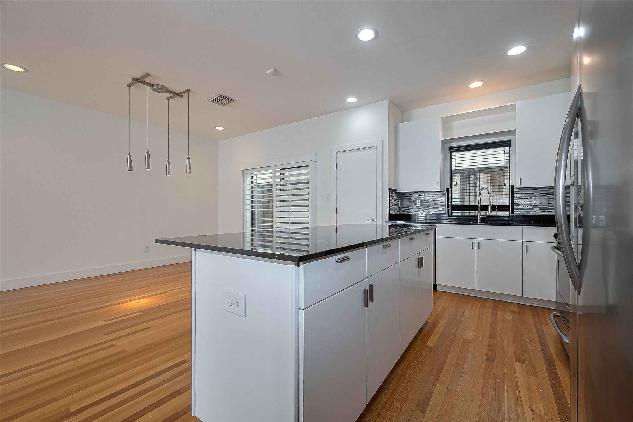 4331 Eigel Street Houston, TX 77007 - Photo 21 of 38 a kitchen with granite countertop white cabinets and white appliances