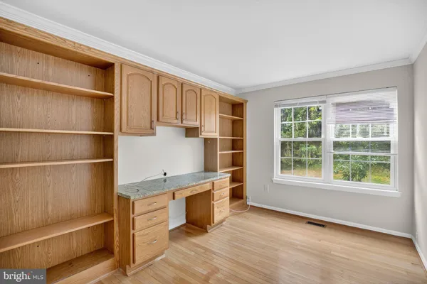 a view of a kitchen with wooden floor and electronic appliances