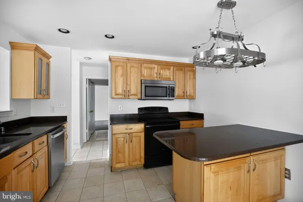 a kitchen with stainless steel appliances a stove sink and microwave