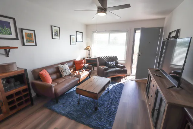 a living room with furniture flat screen tv and a couch