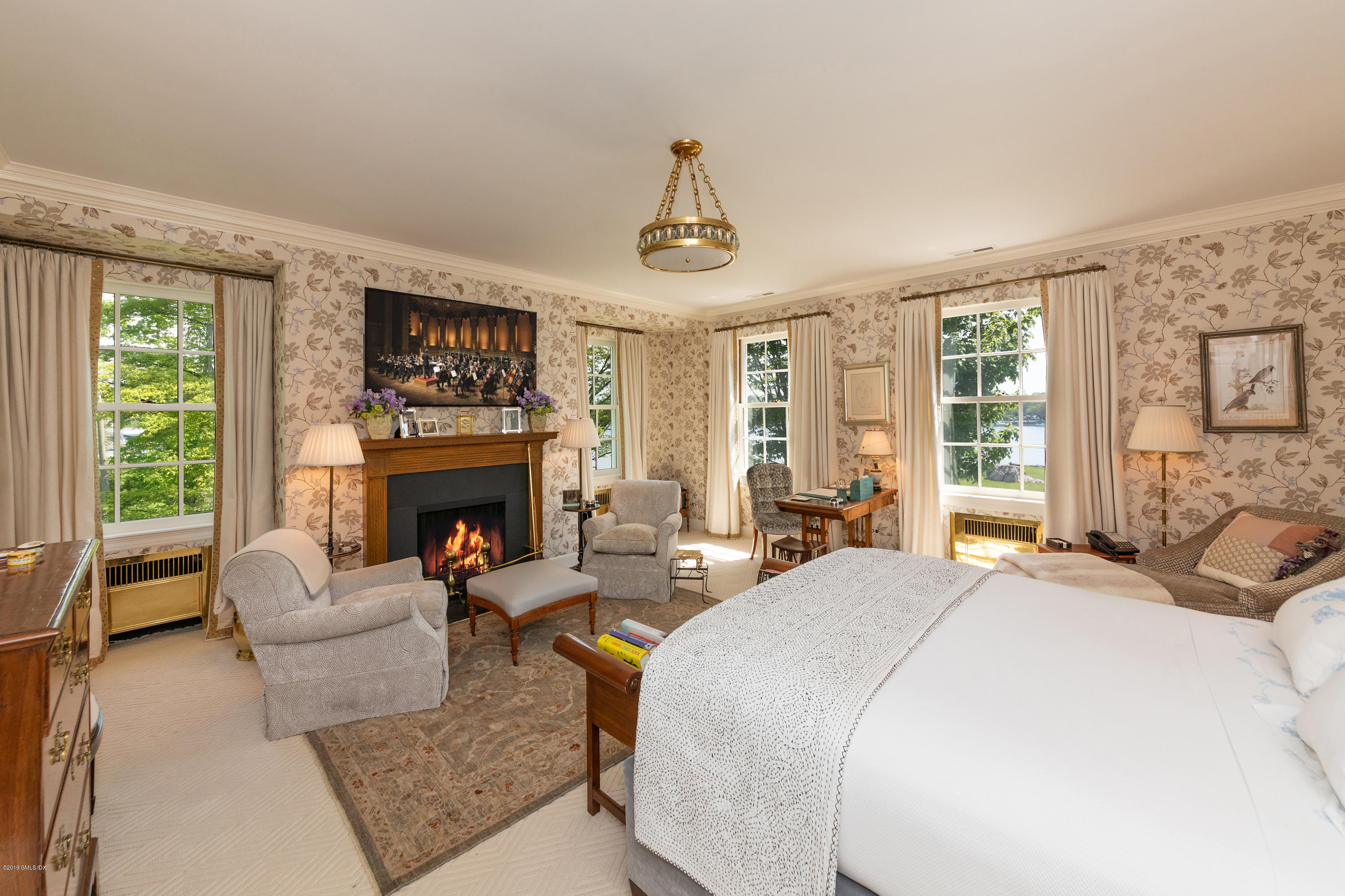 23 Smith Road Greenwich, CT 06830 - Photo 18 of 52 a living room with furniture large window and a fireplace