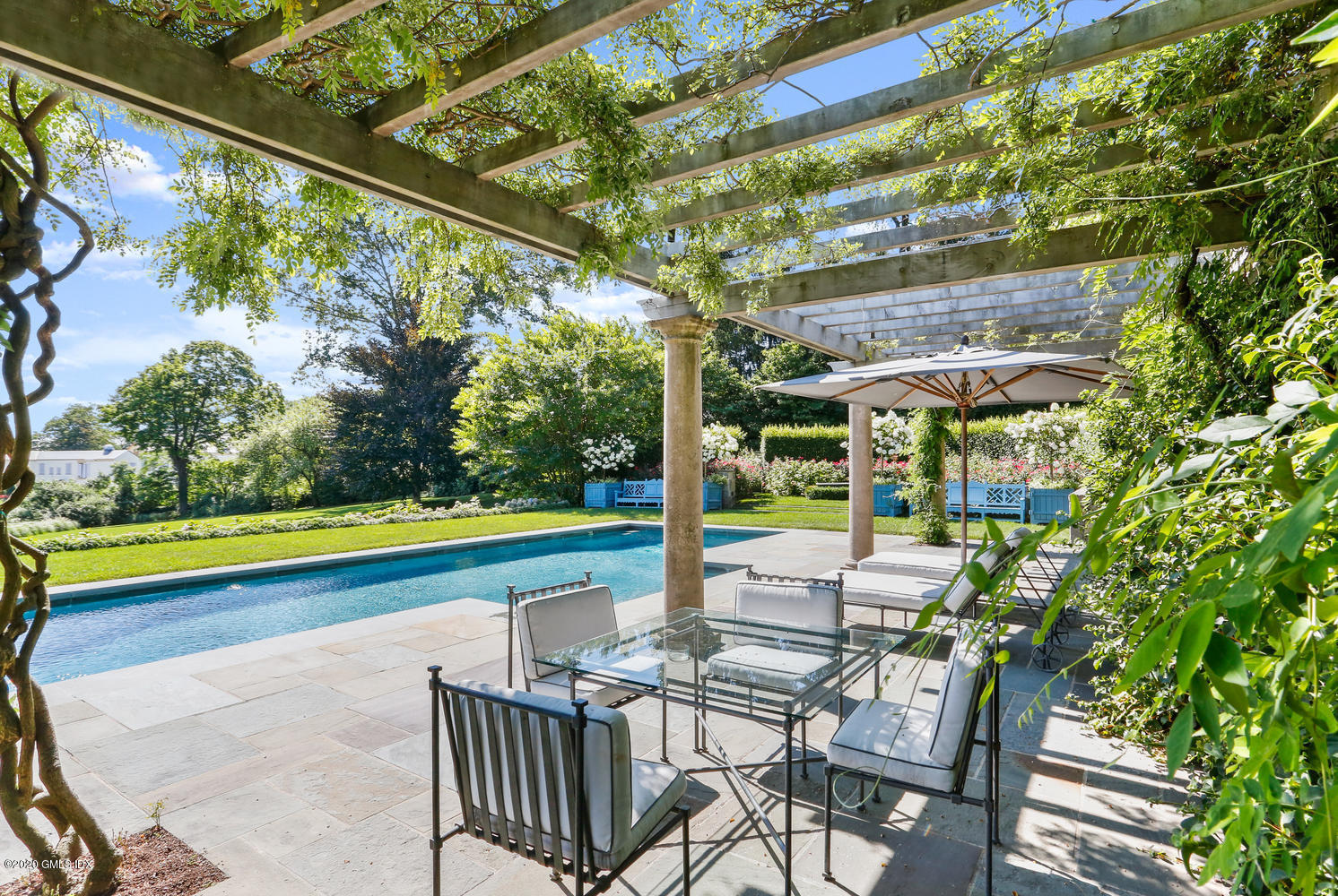 23 Smith Road Greenwich, CT 06830 - Photo 30 of 52 a view of swimming pool with lawn chairs and a yard