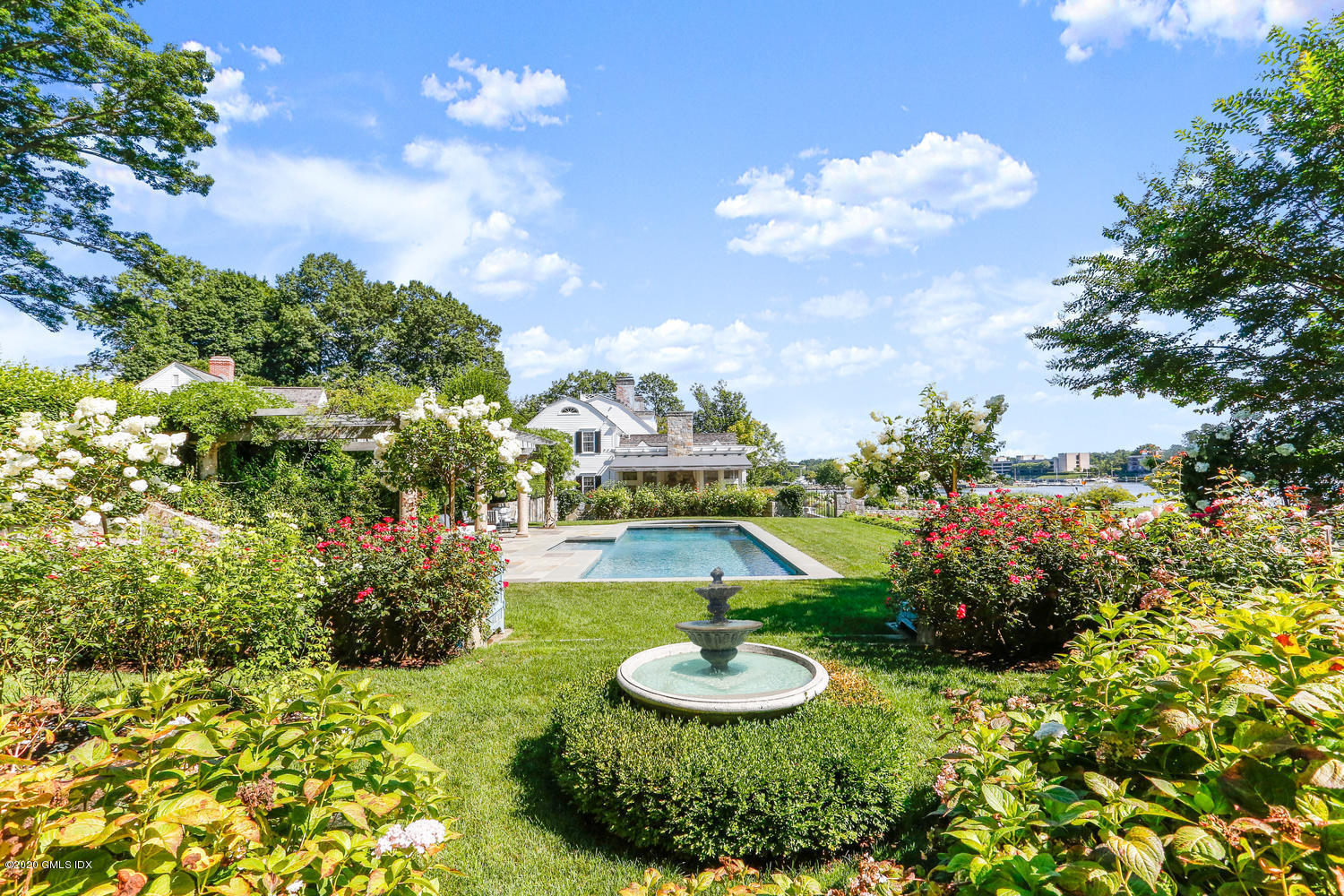 23 Smith Road Greenwich, CT 06830 - Photo 32 of 52 a swimming pool with plants and large trees