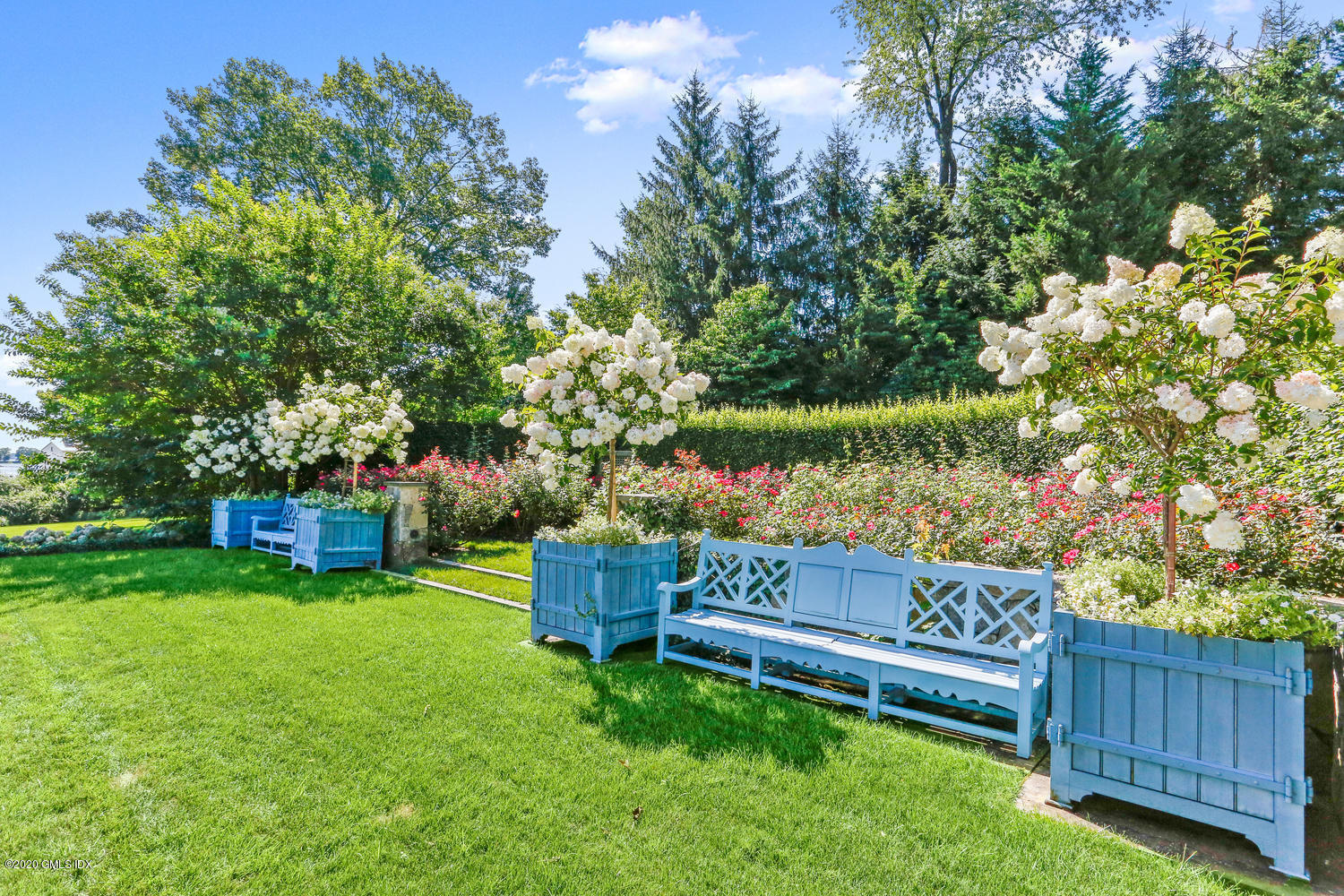 23 Smith Road Greenwich, CT 06830 - Photo 33 of 52 a view of a wooden bench sitting in the garden