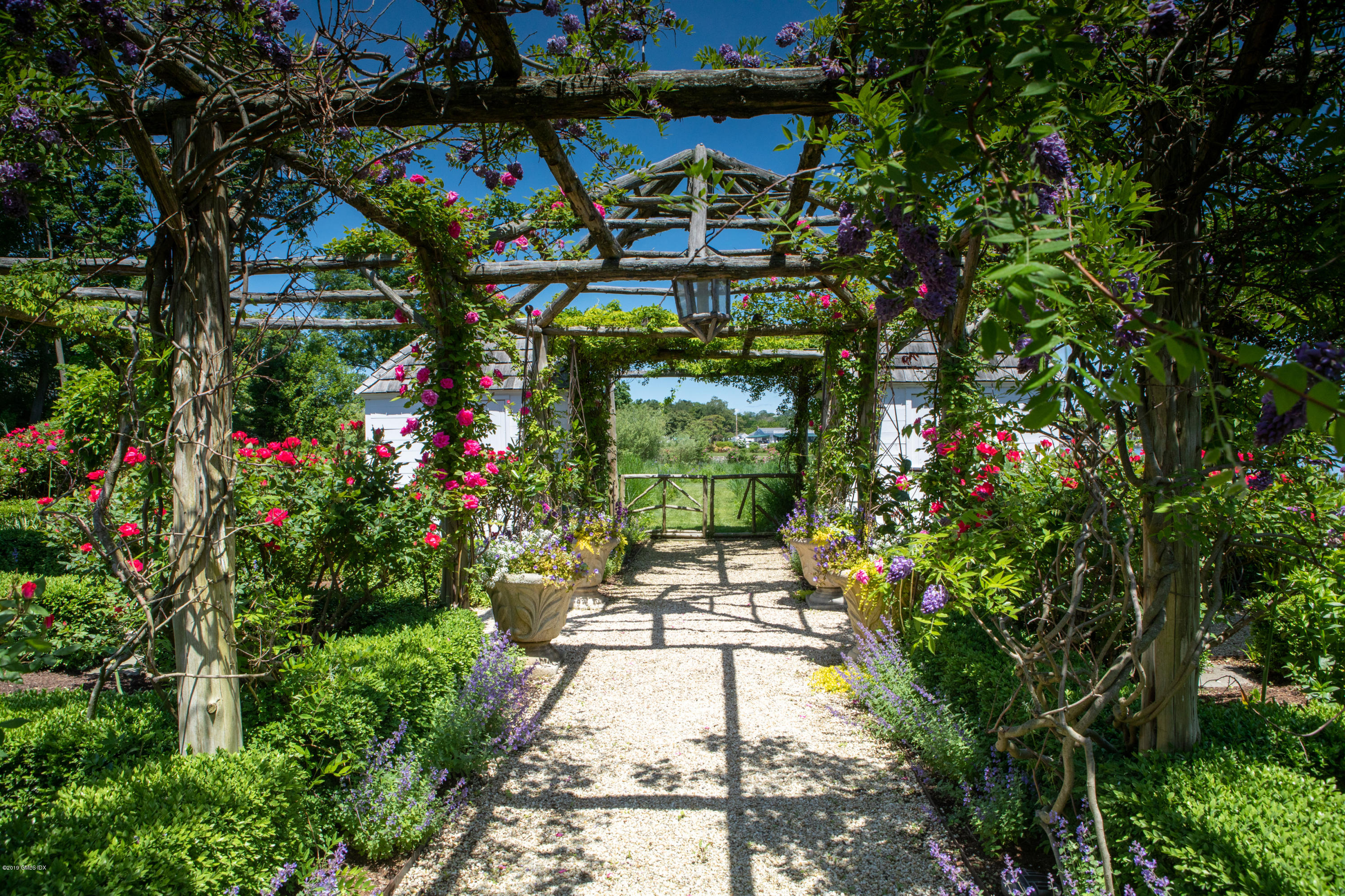 23 Smith Road Greenwich, CT 06830 - Photo 38 of 52 a view of a pathway of a house with flower garden