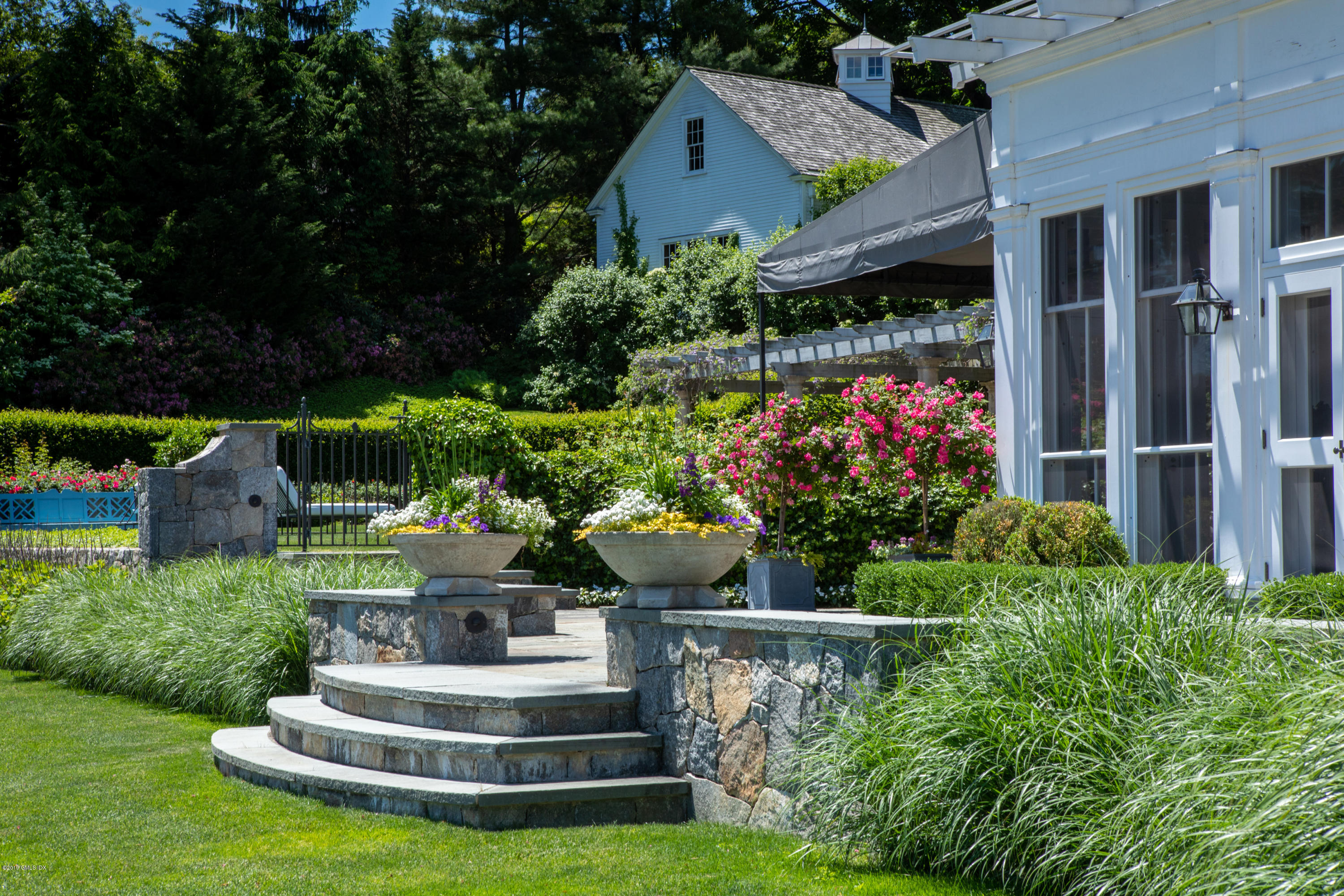 23 Smith Road Greenwich, CT 06830 - Photo 42 of 52 a view of a house with a yard and potted plants