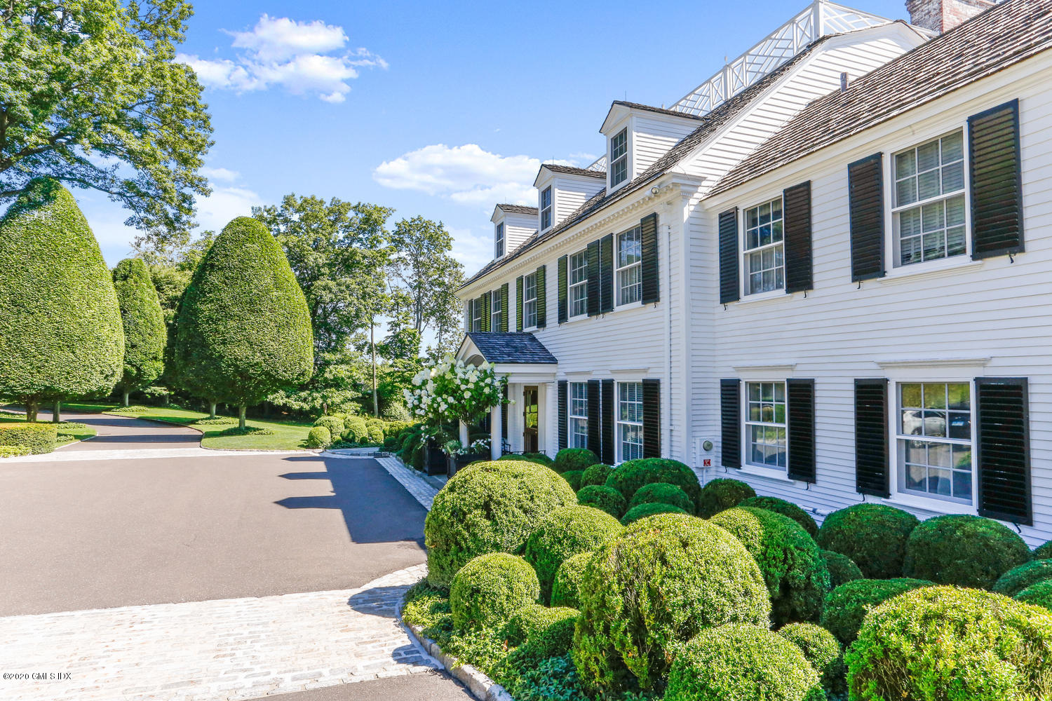 23 Smith Road Greenwich, CT 06830 - Photo 6 of 52 a view of a house with brick walls plants and large tree