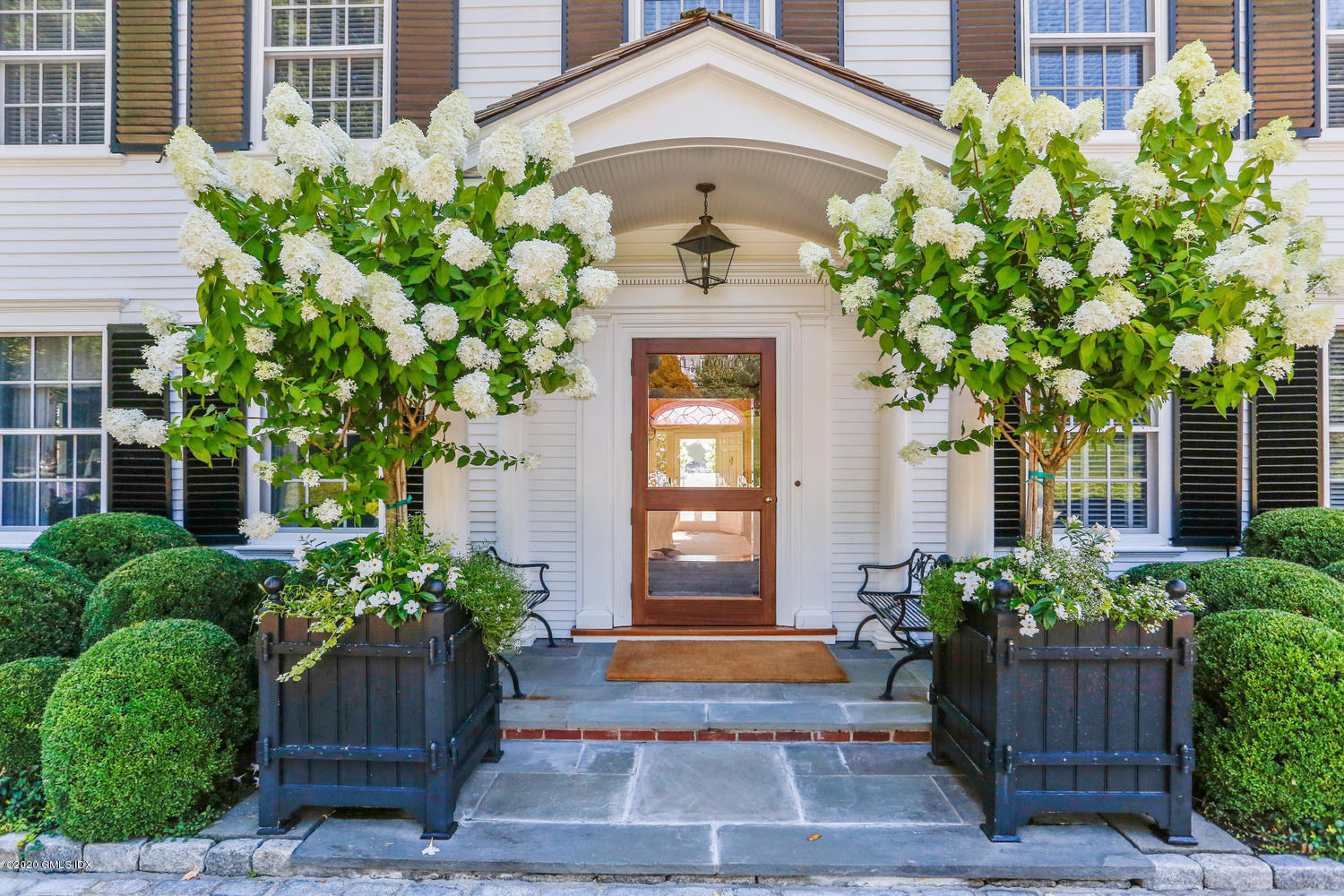 23 Smith Road Greenwich, CT 06830 - Photo 7 of 52 a front view of a house with garden