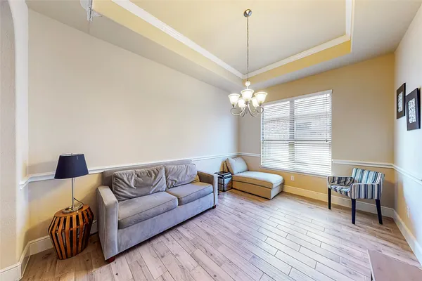 a living room with furniture and a chandelier