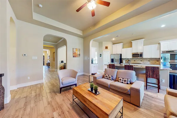 a living room with furniture and a wooden floor