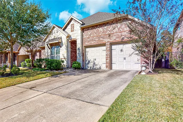 a front view of a house with a yard and a garage
