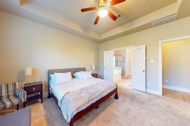 a bedroom with a bed and ceiling fan