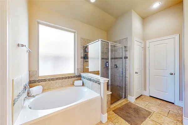 a bathroom with a bathtub and a shower