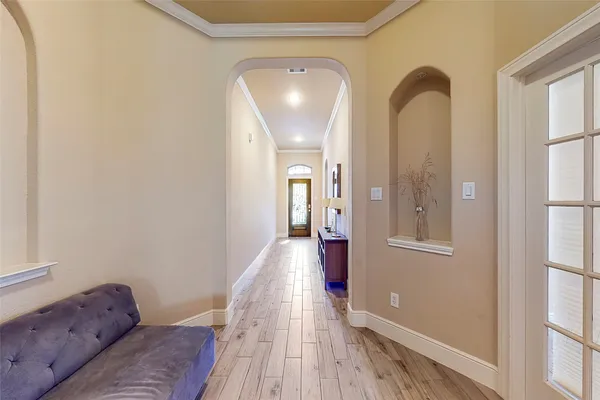 a view of entryway and hall with wooden floor