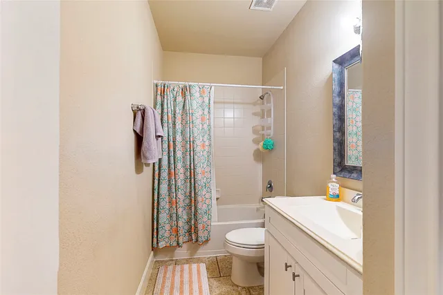 a bathroom with a sink a toilet a shower and a mirror