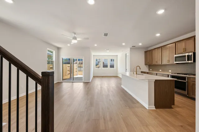a view of kitchen with refrigerator and window