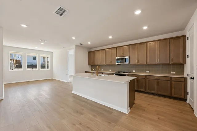 a kitchen with stainless steel appliances granite countertop a sink and cabinets