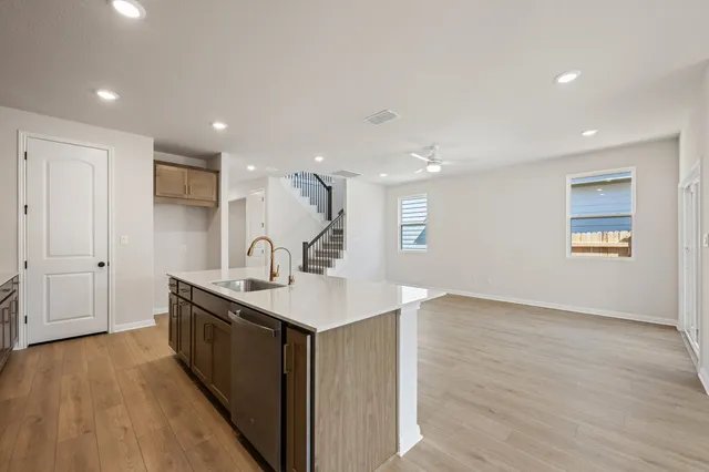 a kitchen with stainless steel appliances white cabinets and a stove top oven