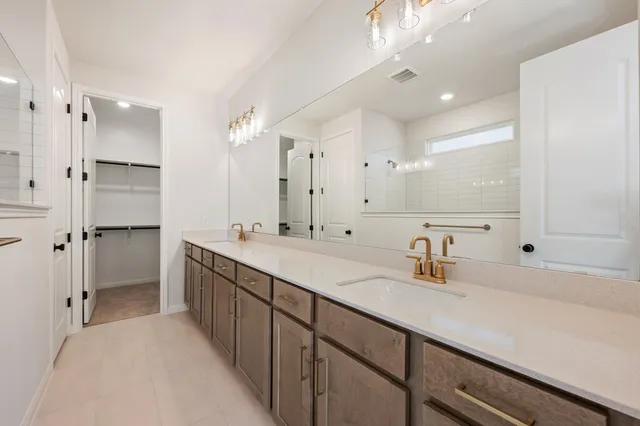 a bathroom with a double vanity sink mirror double and shower
