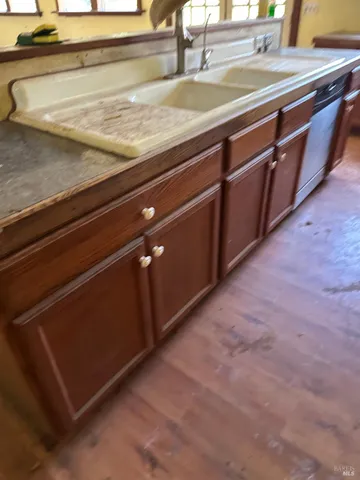 a kitchen with wooden cabinets and a stove top oven