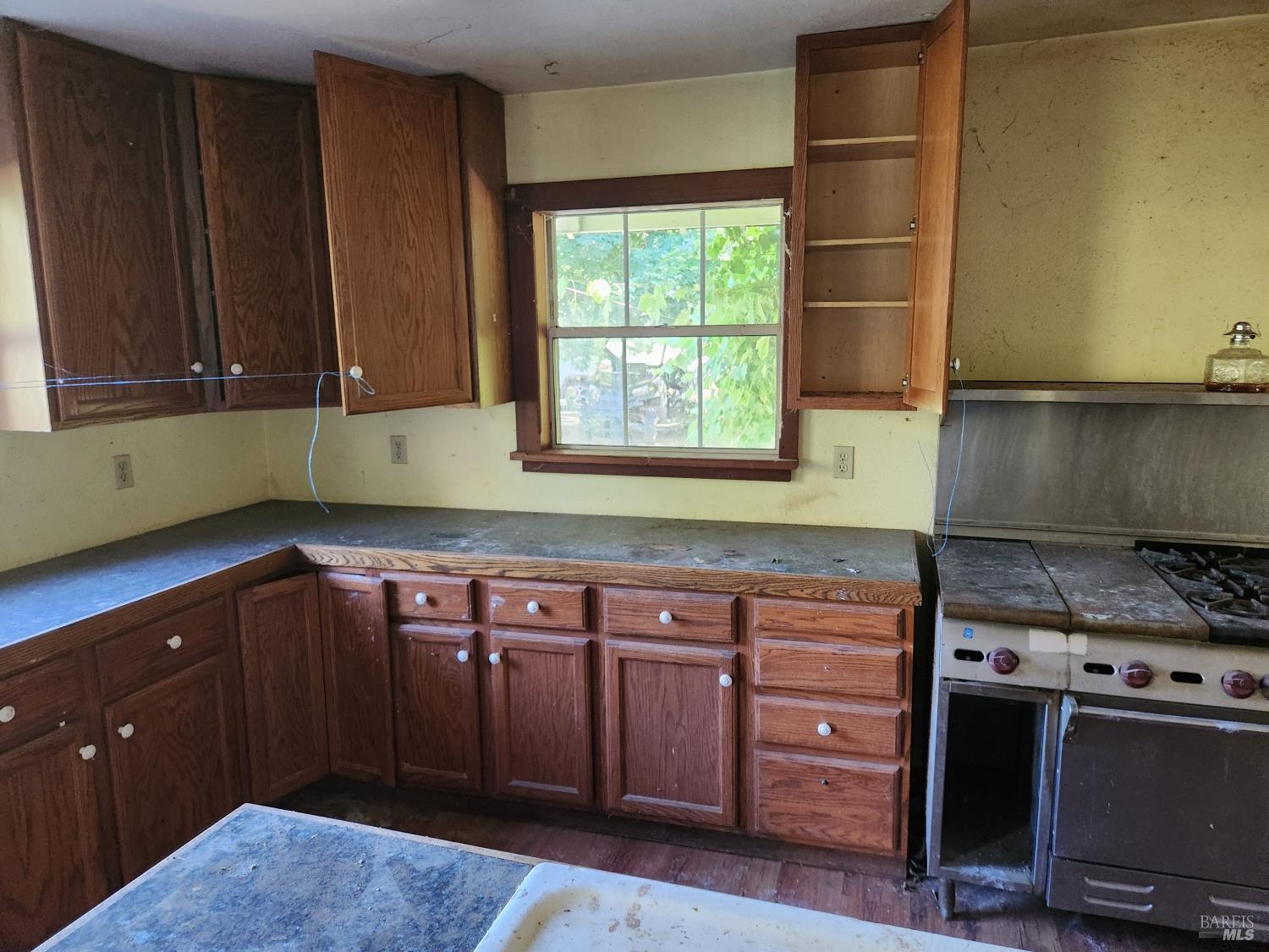 13333 Low Gap Road Ukiah, CA 95482 - Photo 10 of 50 a kitchen with granite countertop a sink cabinets and stainless steel appliances