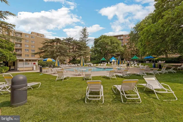 a swimming pool with outdoor seating and yard