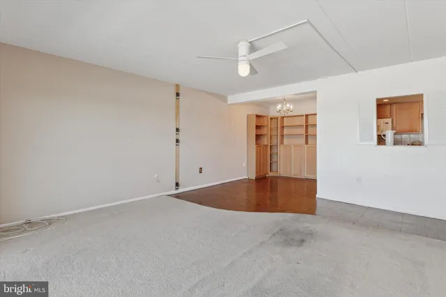 an empty room with windows and closet