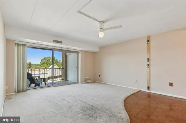a view of a room with large windows and a chandelier