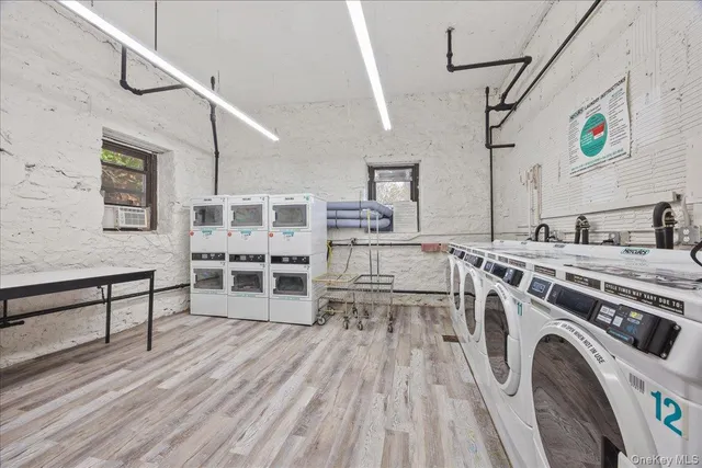 a view of a kitchen with furniture and wooden floor