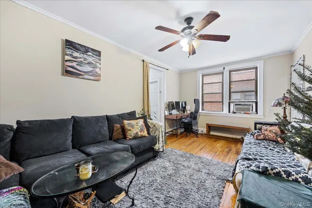a living room with furniture ceiling fan and a rug