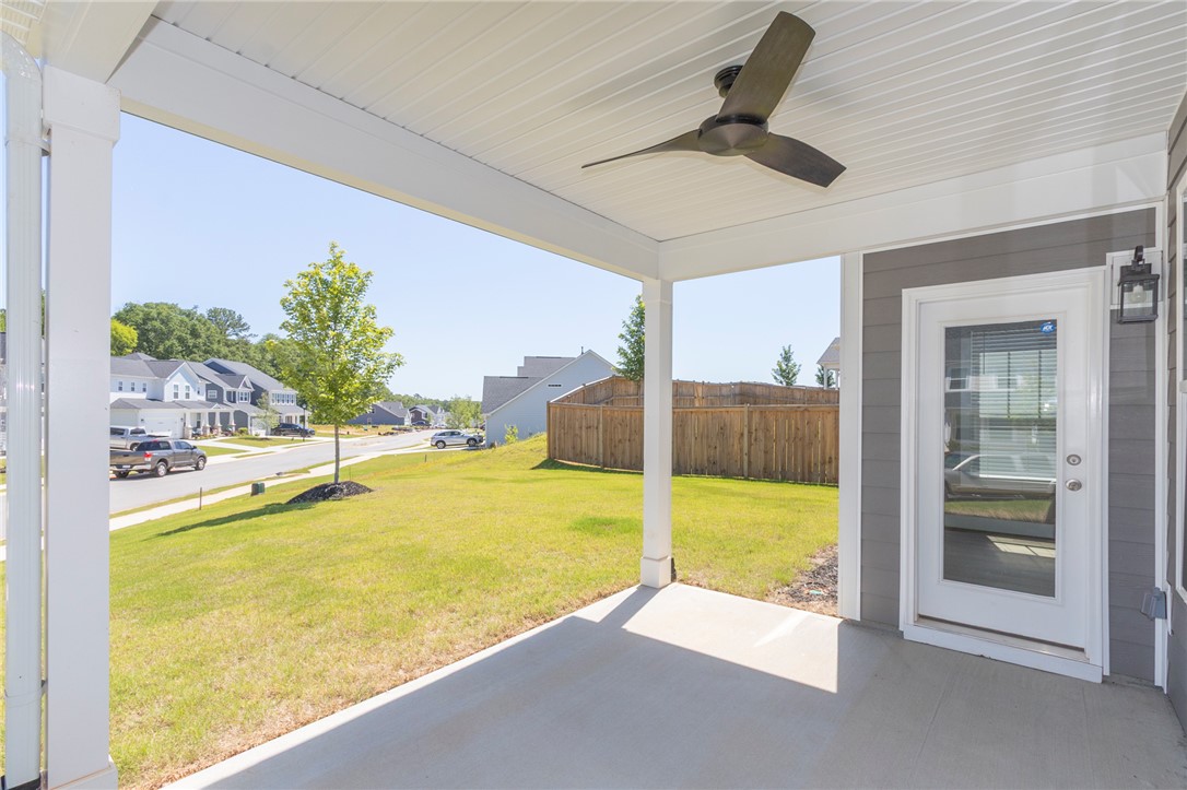 607 WH Kay Lane Anderson, SC 29621 - Photo 39 of 48 Unwind outdoors on the covered patio, gazing across the verdant lawn toward a tranquil neighborhood street.