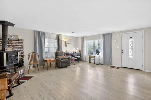 a living room with furniture window and wooden floor