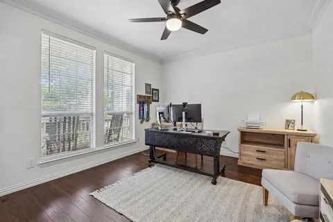 a view of a workspace with furniture and a window